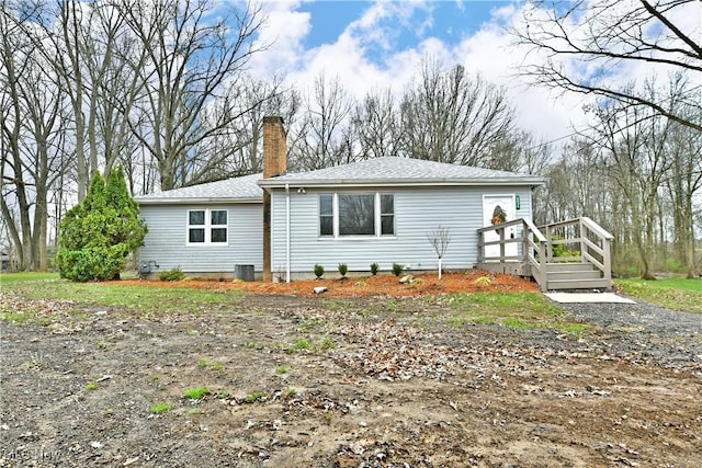 5099 Norquest Blvd, Youngstown, OH 44515 - rear view of house featuring a chimney and a shingled roof