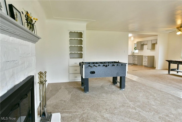 5099 Norquest Blvd, Youngstown, OH 44515 - playroom with light colored carpet, ceiling fan, and a fireplace