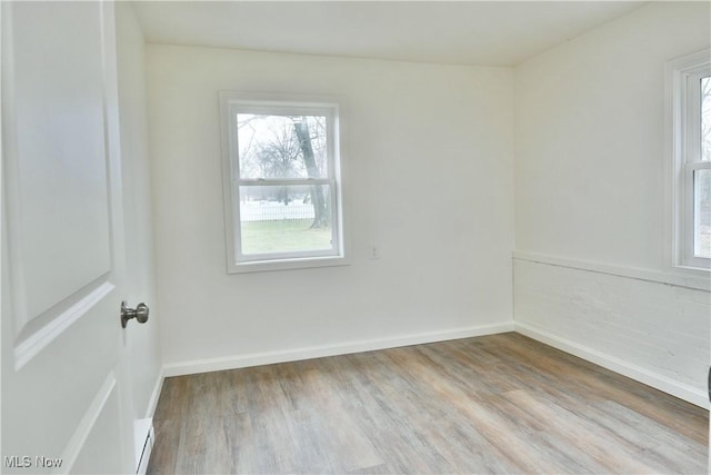 5099 Norquest Blvd, Youngstown, OH 44515 - empty room featuring wood finished floors, a wealth of natural light, and a baseboard radiator