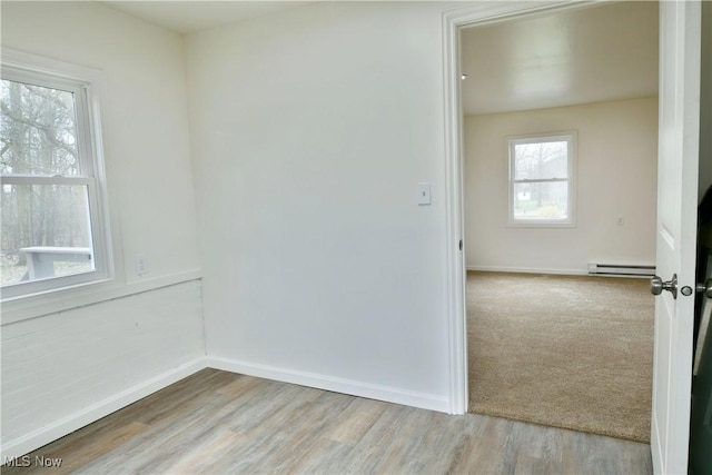 5099 Norquest Blvd, Youngstown, OH 44515 - empty room with a baseboard radiator, baseboards, and wood finished floors