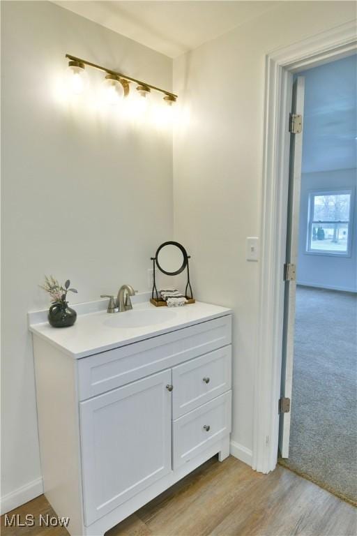 5099 Norquest Blvd, Youngstown, OH 44515 - bathroom with baseboards, wood finished floors, and vanity