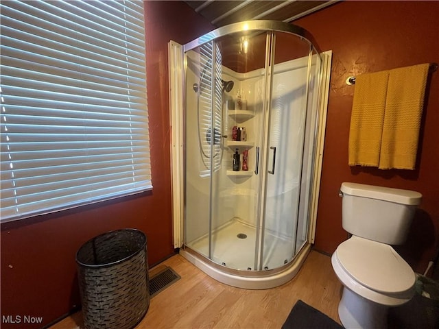 1641 Sharon Ave, Zanesville, OH 43701 - bathroom with a shower stall, wood finished floors, visible vents, and toilet