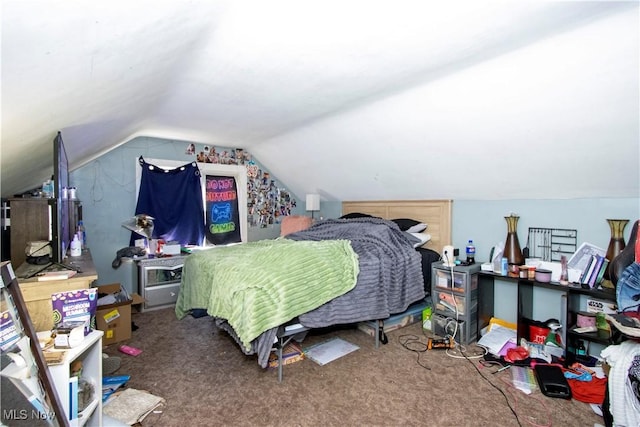 bedroom with vaulted ceiling and carpet