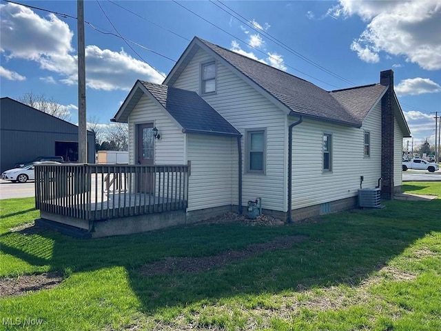 7431 Middlebranch Ave NE, Canton, OH 44721 - rear view of property with a wooden deck, a lawn, a shingled roof, and central AC