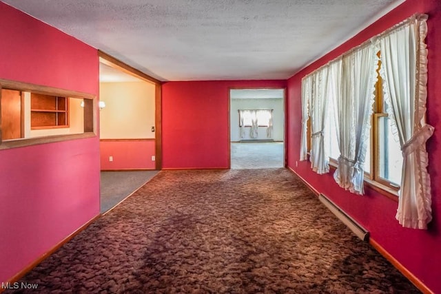 2104 Tanner Ave SW, Canton, OH 44706 - corridor featuring a baseboard heating unit, baseboards, carpet, and a textured ceiling