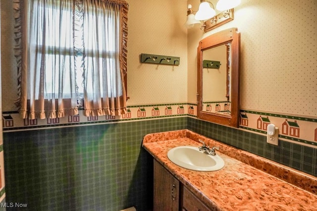 2104 Tanner Ave SW, Canton, OH 44706 - bathroom with wainscoting, vanity, and wallpapered walls
