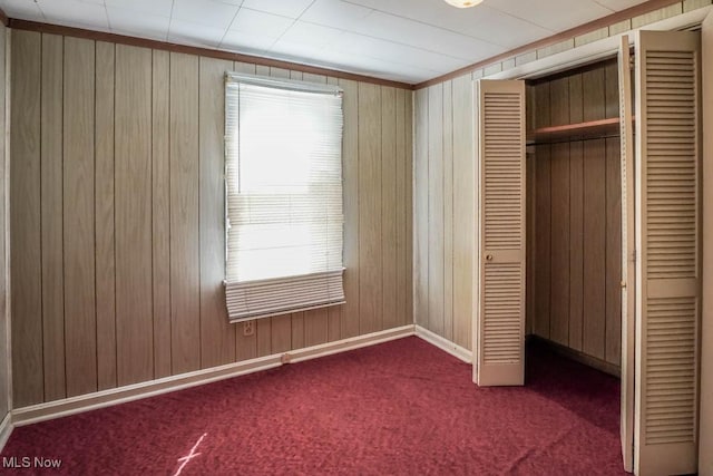 2104 Tanner Ave SW, Canton, OH 44706 - unfurnished bedroom featuring wood walls, a closet, and multiple windows
