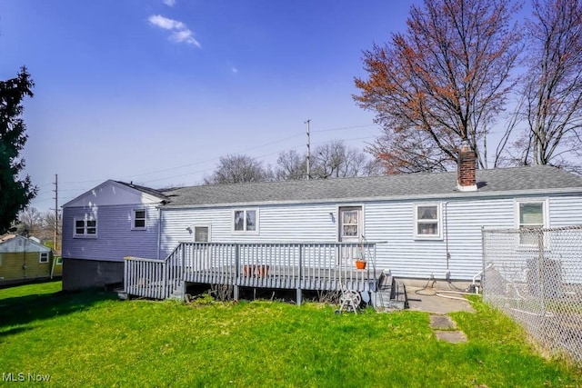 2104 Tanner Ave SW, Canton, OH 44706 - rear view of property with a yard, a shingled roof, a chimney, and a deck