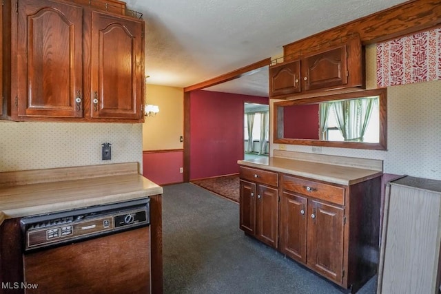 2104 Tanner Ave SW, Canton, OH 44706 - kitchen featuring light countertops, wallpapered walls, dishwasher, and dark colored carpet