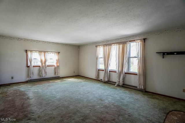 2104 Tanner Ave SW, Canton, OH 44706 - carpeted spare room with baseboard heating, baseboards, and a textured ceiling