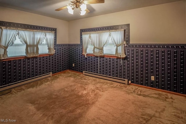2104 Tanner Ave SW, Canton, OH 44706 - carpeted empty room featuring a wainscoted wall, baseboard heating, and a ceiling fan