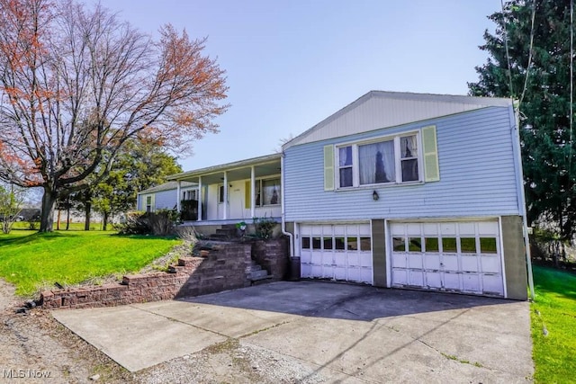 2104 Tanner Ave SW, Canton, OH 44706 - view of front of house with an attached garage, driveway, covered porch, and a front yard