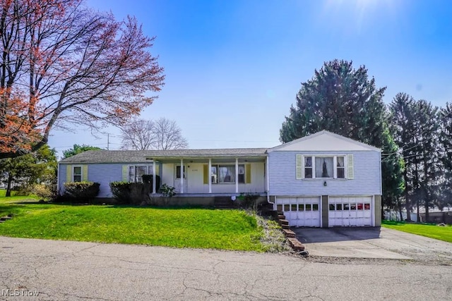 2104 Tanner Ave SW, Canton, OH 44706 - single story home featuring an attached garage, driveway, a front lawn, and covered porch