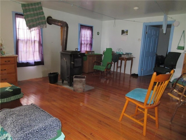living room featuring wood finished floors and a wood stove