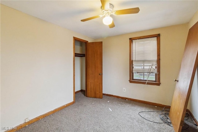 unfurnished bedroom featuring baseboards, carpet, a closet, and ceiling fan