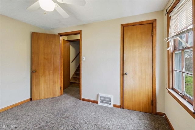 unfurnished bedroom featuring carpet floors, visible vents, and baseboards
