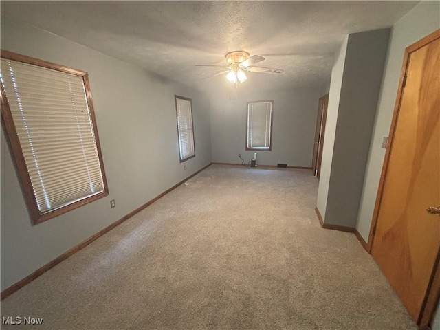 405 Oak Knoll Ave SE, Warren, OH 44483 - unfurnished bedroom featuring a ceiling fan, baseboards, and light colored carpet