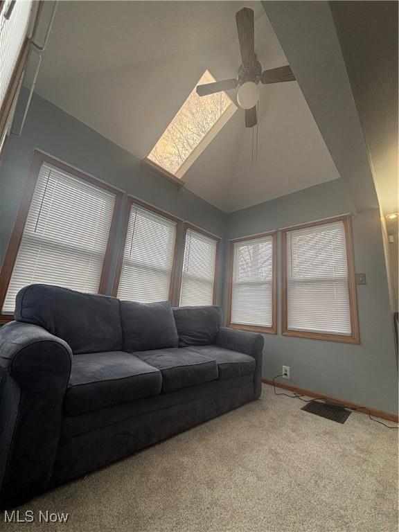 405 Oak Knoll Ave SE, Warren, OH 44483 - living room with vaulted ceiling, carpet, a ceiling fan, and baseboards