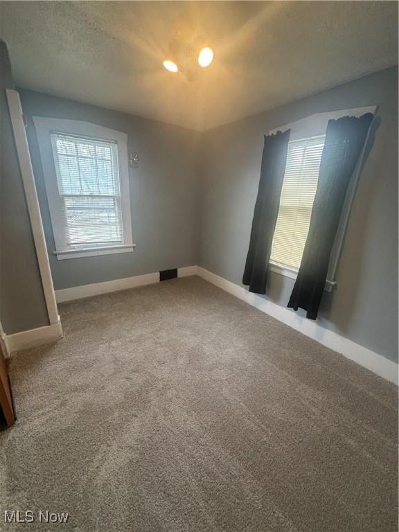 405 Oak Knoll Ave SE, Warren, OH 44483 - unfurnished room with recessed lighting, plenty of natural light, carpet floors, and baseboards