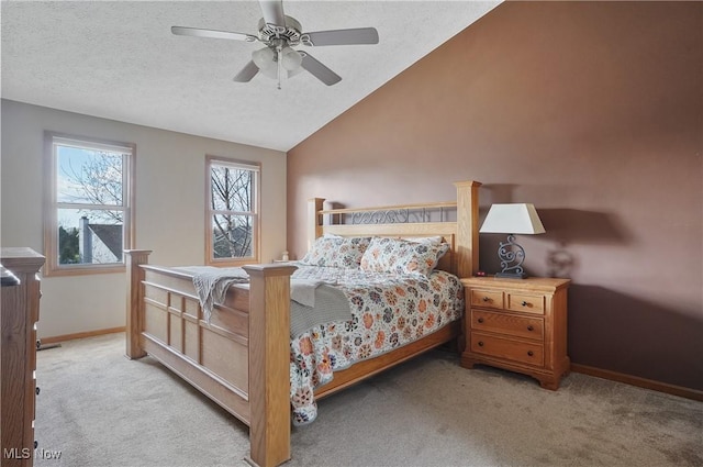 carpeted bedroom featuring ceiling fan, baseboards, vaulted ceiling, and a textured ceiling
