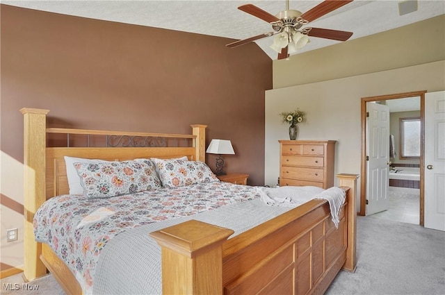 bedroom with light carpet, a ceiling fan, connected bathroom, and high vaulted ceiling
