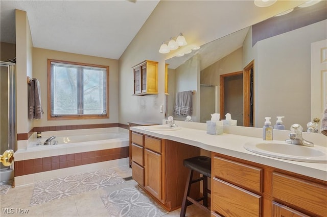 bathroom with a shower stall, a garden tub, and a sink