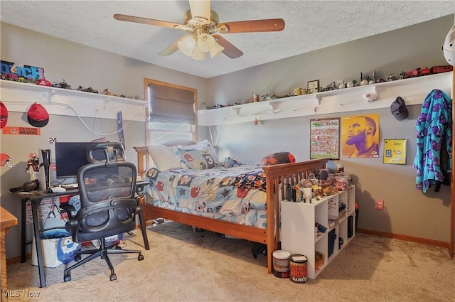 carpeted bedroom with baseboards, a ceiling fan, and a textured ceiling