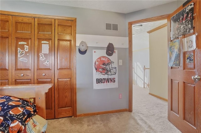 carpeted bedroom with baseboards and visible vents
