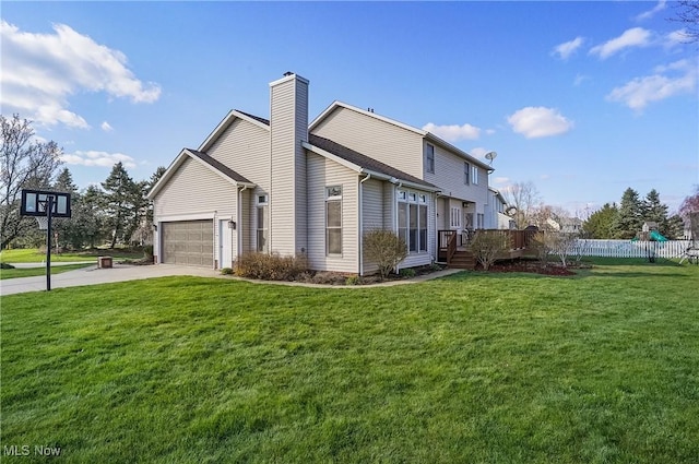 view of side of home with concrete driveway, a deck, an attached garage, fence, and a yard