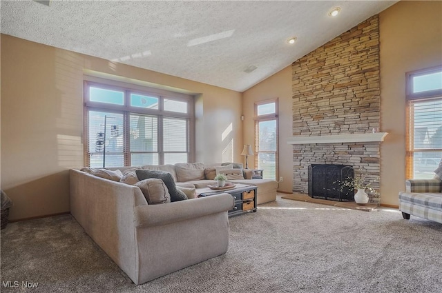 living area with a textured ceiling, carpet, a healthy amount of sunlight, and high vaulted ceiling