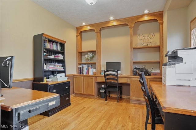 office space featuring light wood-style floors and recessed lighting