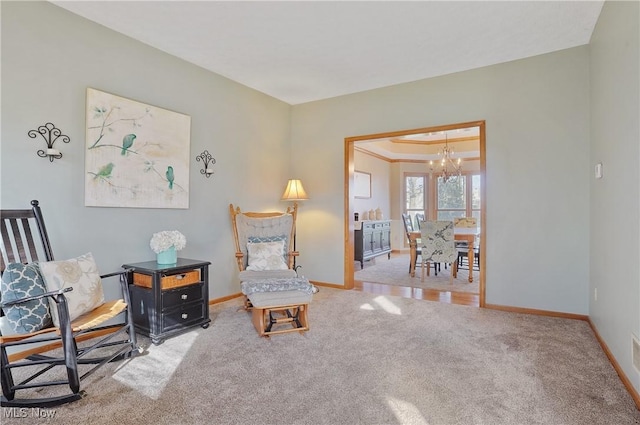 sitting room featuring baseboards, carpet, and a chandelier