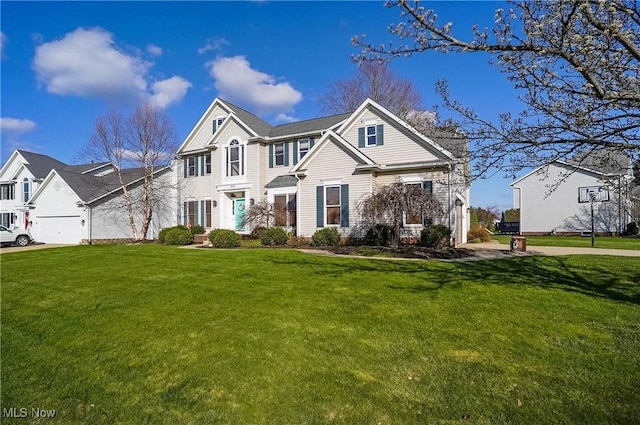 traditional home featuring a garage, a front lawn, and concrete driveway