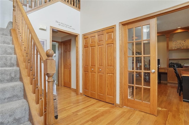 interior space with wood finished floors, baseboards, and stairway
