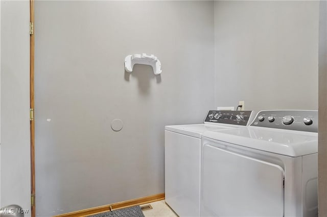 laundry area featuring separate washer and dryer and laundry area