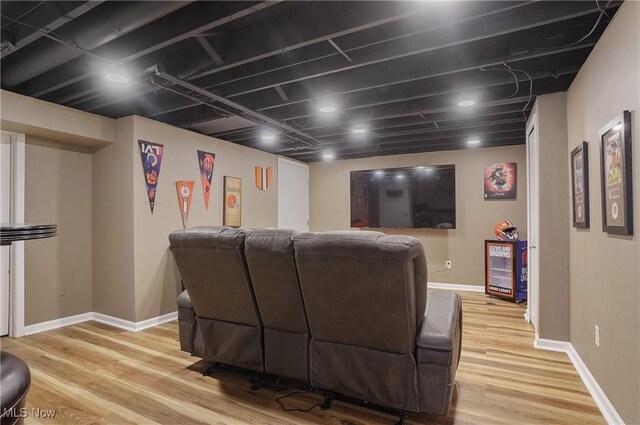 home theater featuring baseboards and light wood-type flooring