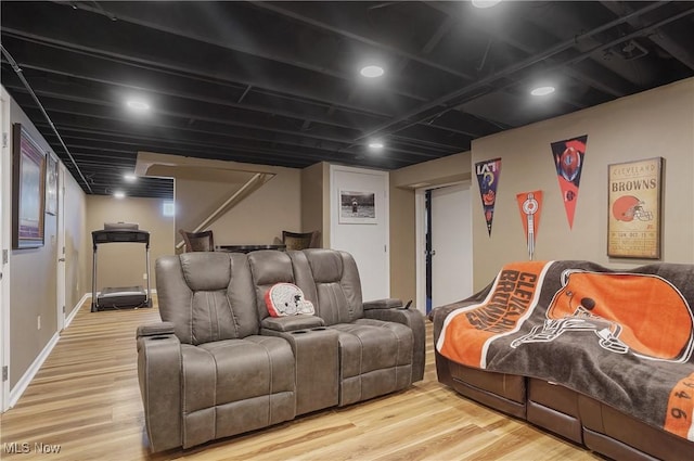 home theater room with baseboards and wood finished floors
