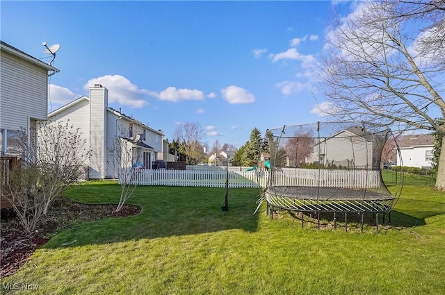 view of yard with fence, a playground, a residential view, and a trampoline