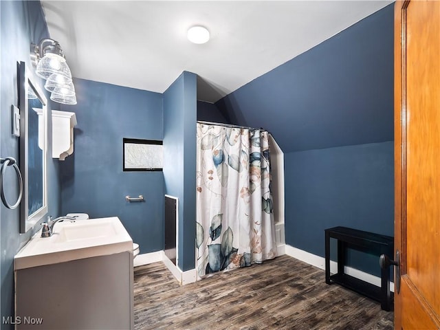 1821 Kenneth Ave, Cleveland, OH 44109 - bathroom featuring lofted ceiling, wood finished floors, vanity, baseboards, and a shower with shower curtain