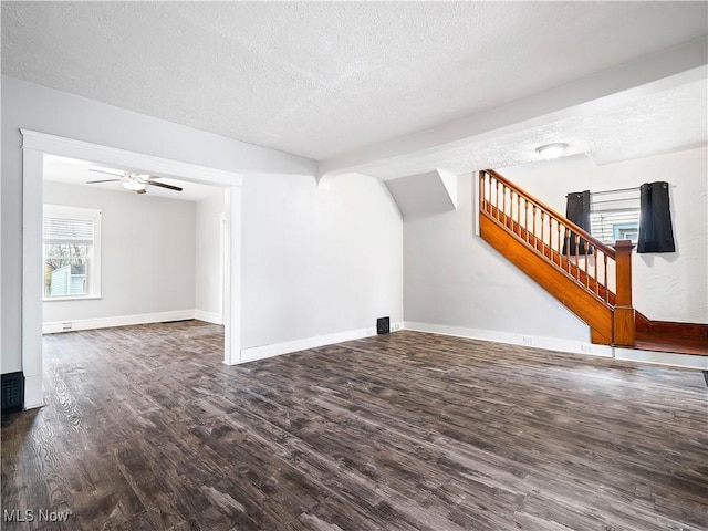 1821 Kenneth Ave, Cleveland, OH 44109 - unfurnished living room featuring baseboards, wood finished floors, a textured ceiling, and stairs