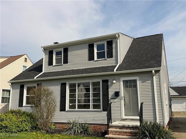 view of front of home featuring roof with shingles