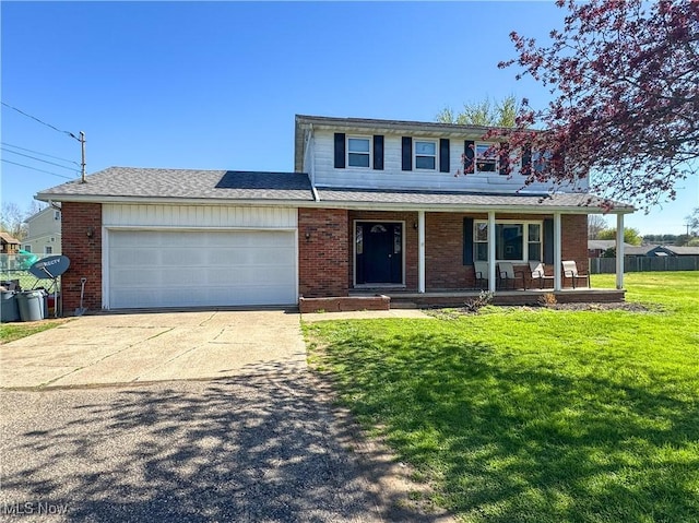 203 57th St, Vienna, WV 26105 - traditional-style house featuring driveway, covered porch, an attached garage, a front yard, and brick siding