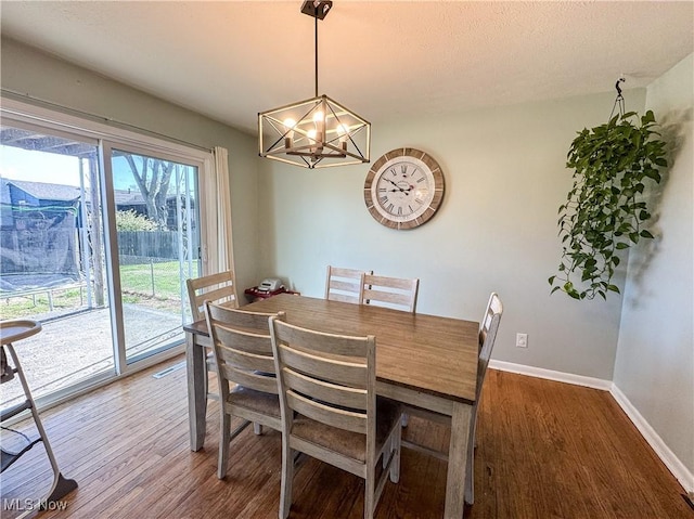 203 57th St, Vienna, WV 26105 - dining room featuring wood finished floors, baseboards, and a notable chandelier