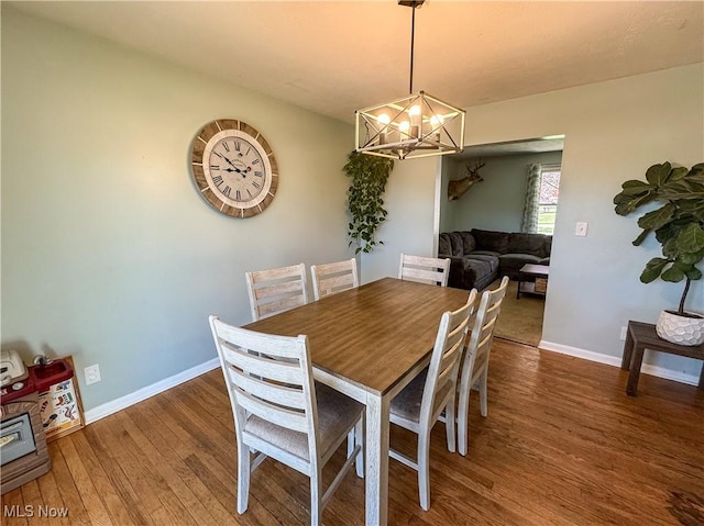 203 57th St, Vienna, WV 26105 - dining space featuring baseboards, a notable chandelier, and wood finished floors