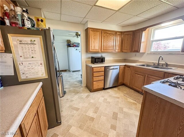 203 57th St, Vienna, WV 26105 - kitchen featuring light countertops, a sink, a paneled ceiling, appliances with stainless steel finishes, and ceiling fan