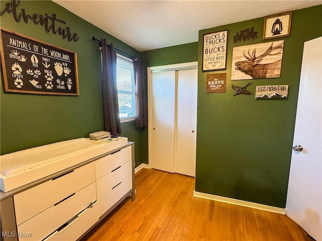 203 57th St, Vienna, WV 26105 - bedroom featuring baseboards, wood finished floors, a textured ceiling, and a closet