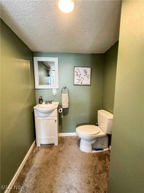203 57th St, Vienna, WV 26105 - bathroom featuring baseboards, a textured ceiling, toilet, and vanity