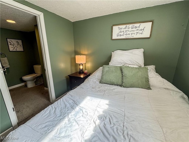 203 57th St, Vienna, WV 26105 - carpeted bedroom featuring baseboards, a textured ceiling, and ensuite bathroom