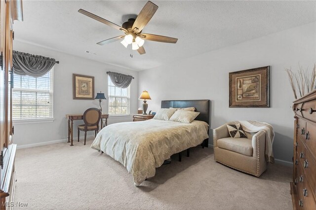 4006 N Steels Cir, Stow, OH 44224 - bedroom with light colored carpet, multiple windows, baseboards, a ceiling fan, and a textured ceiling