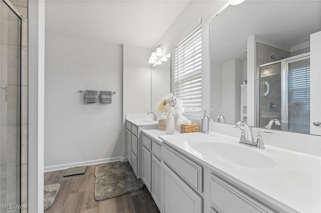 4006 N Steels Cir, Stow, OH 44224 - full bathroom with wood finished floors, a shower stall, double vanity, and baseboards